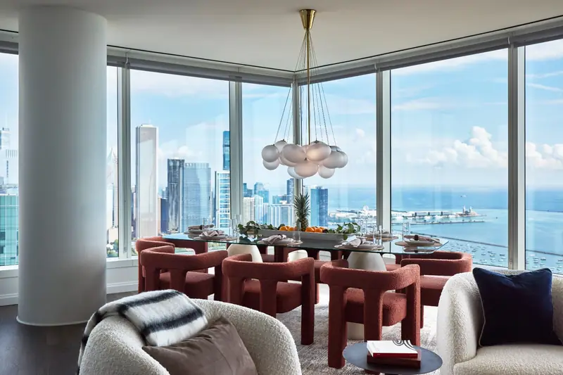 Dining room with lake and skyline views from a high floor