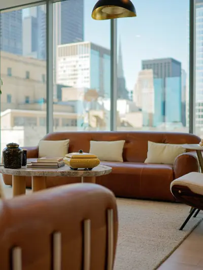 Living room with leather seating and floor-to-ceiling windows